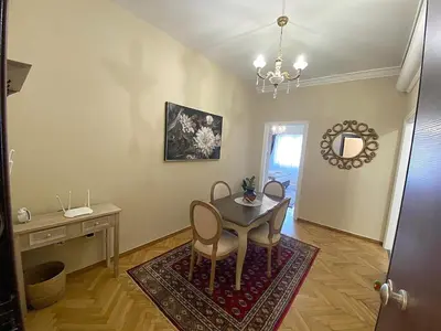 a dining room with a table and chairs and a mirror at Check Point - Acropolis View A in Athens