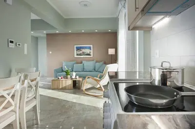 a kitchen and living room with a blue couch at Διαμερίσματα στο Δυτικό Μοσχάτο in Piraeus