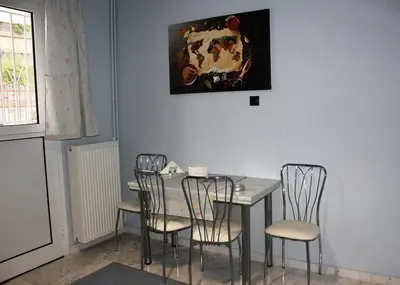 a dining room with a table and four chairs at Modern house next to Metro station to explore Athens in Athens
