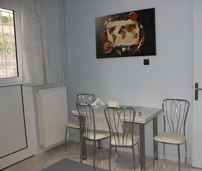 a dining room with a table and four chairs at Modern house next to Metro station to explore Athens in Athens