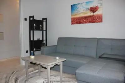 a living room with a blue couch and a table at Modern house next to Metro station to explore Athens in Athens