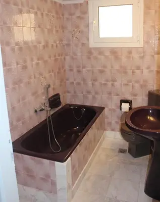 a bathroom with a tub and a toilet and a sink at Modern house next to Metro station to explore Athens in Athens