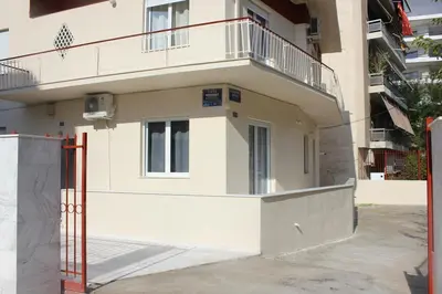 a white building with a balcony on top of it at Modern house next to Metro station to explore Athens in Athens