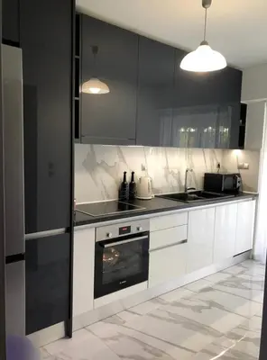 a kitchen with white cabinets and a stove top oven at Lovely Faliro Apartment next to the sea. in Athens