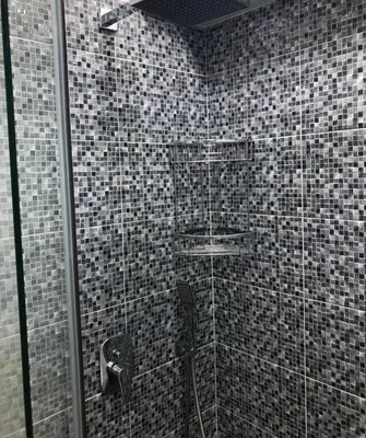 a bathroom with a shower with black and white tiles at Lovely Faliro Apartment next to the sea. in Athens