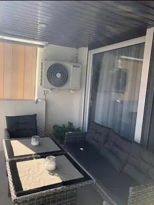 a small living room with a couch and a table at Lovely Faliro Apartment next to the sea. in Athens