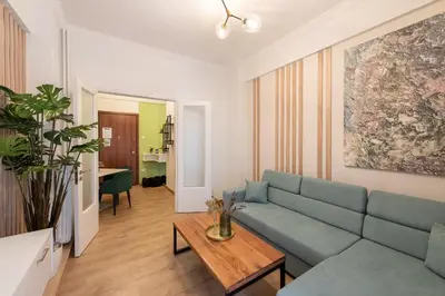 a living room with a blue couch and a table at MEDLUXE COMFORT APARTMENT in Athens