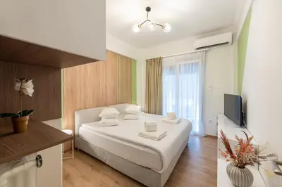 a hotel room with a bed and a television at MEDLUXE COMFORT APARTMENT in Athens