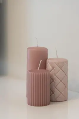 two pink candles sitting next to a suitcase at MEDLUXE COMFORT APARTMENT in Athens