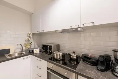 a kitchen with a stove and a sink at MEDLUXE COMFORT APARTMENT in Athens