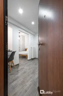 a door leading into a room with a bedroom at Embassy Studio in Athens