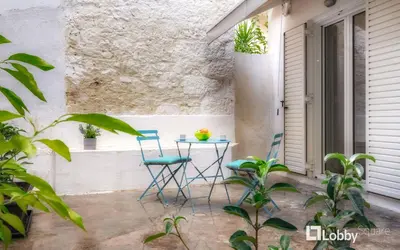 a patio with two chairs and a table at Embassy Studio in Athens