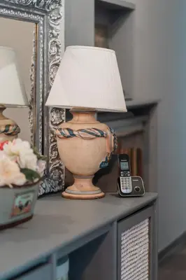 a lamp sitting on top of a table with a phone at Ioanna's Hellenic Hospitality in Athens