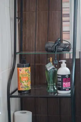 a shelf with toiletries on it in a bathroom at Ioanna's Hellenic Hospitality in Athens