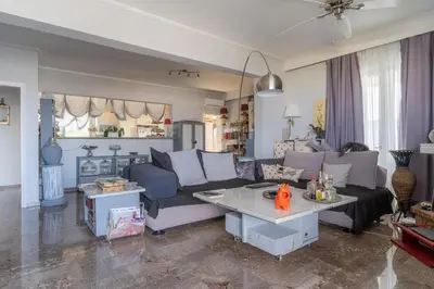 a living room with a couch and a table at Ioanna's Hellenic Hospitality in Athens
