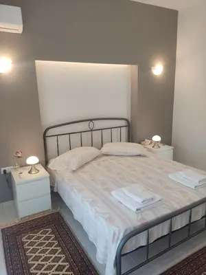 a bedroom with a large bed with two night stands at Katerina summerhouse in Dhaskalión