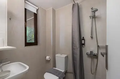 a bathroom with a shower and a toilet and a sink at Studio Krinon - Paleo Psychiko in Athens