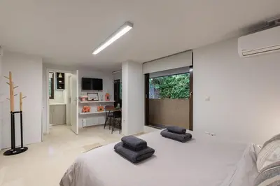 a bedroom with a bed with two stools on it at Studio Krinon - Paleo Psychiko in Athens
