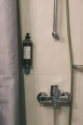 a shower with a soap dispenser on a wall at Studio Krinon - Paleo Psychiko in Athens