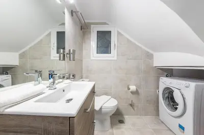 a bathroom with a sink and a washing machine at Luxury Penthouse in Kolonaki with view in Athens