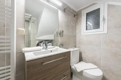 a bathroom with a white sink and a toilet at Luxury Penthouse in Kolonaki with view in Athens