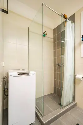 a bathroom with a shower with a glass door at The excellent home in Athens