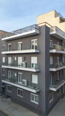 an apartment building with balconies on the side of it at Eos Residence in Athens