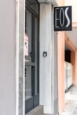 a store front door with a sign on it at Eos Residence in Athens