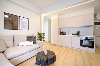 a living room with a couch and a table at Eos Residence in Athens