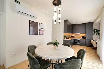 a dining room with a table and chairs at Eos Residence in Athens