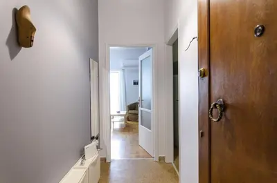 a hallway with a door leading to a room at Colourful apartment under the Acropolis in Athens
