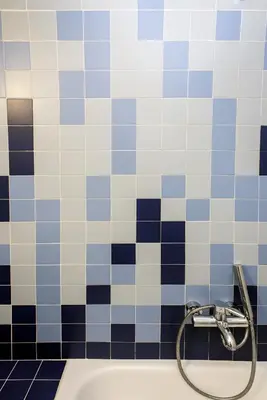 a bathroom with blue and white tiled walls and a sink at Colourful apartment under the Acropolis in Athens