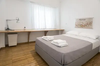 a bedroom with a bed with two towels on it at Colourful apartment under the Acropolis in Athens