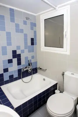 a bathroom with a tub and a toilet and a sink at Colourful apartment under the Acropolis in Athens