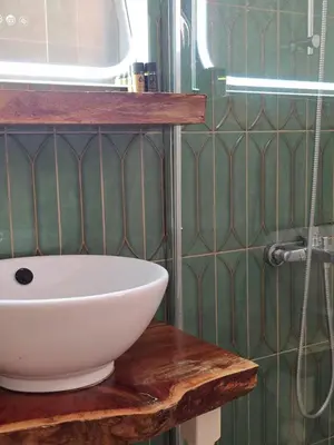 a bathroom with a white sink and a shower at Penthouse Nea Smirni in Athens