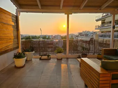 a balcony with a view of a ship at Penthouse Nea Smirni in Athens