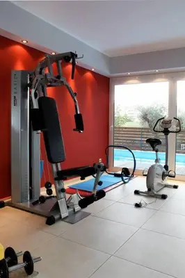 a gym with two tread machines in a room at The Love suite 1 Athens Riviera in Athens