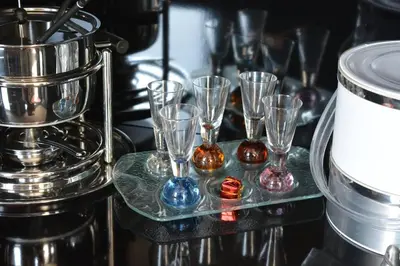 a group of wine glasses sitting on a glass tray at The Love suite 1 Athens Riviera in Athens