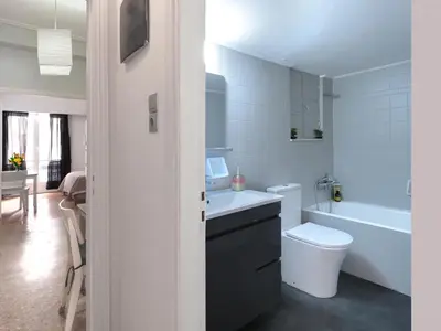 a bathroom with a sink and a toilet and a tub at Homy Pagrati flat 100 Mbps, 12' to Panathenaic Stadium, 5' to Metro in Athens