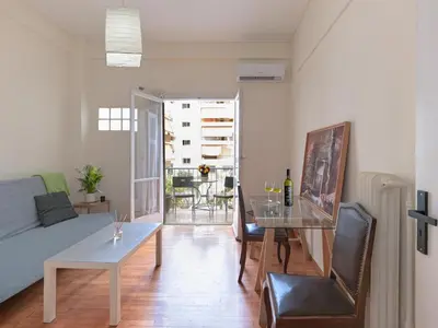a living room with a couch and a table at Homy Pagrati flat 100 Mbps, 12' to Panathenaic Stadium, 5' to Metro in Athens