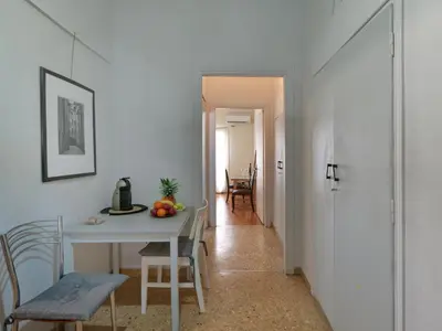 a kitchen and dining room with a table and chairs at Homy Pagrati flat 100 Mbps, 12' to Panathenaic Stadium, 5' to Metro in Athens