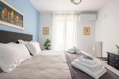 a bedroom with a large bed with towels on it at Athens Escape in Athens