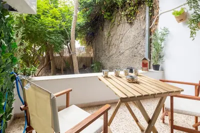 a wooden table and chairs on a patio at Athens Escape in Athens