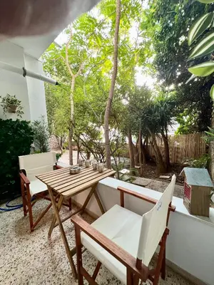a patio with a wooden table and chairs at Athens Escape in Athens