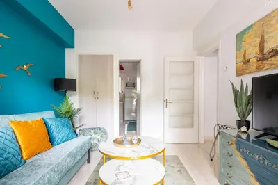 a living room with a couch and a tv at Athens Escape in Athens