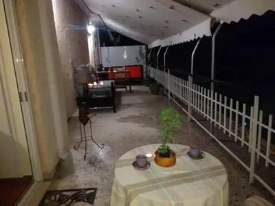 a room with a table in a room with a fence at Cosy penthouse next to metro in Athens