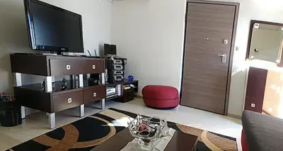 a living room with a flat screen tv and a couch at Cosy penthouse next to metro in Athens