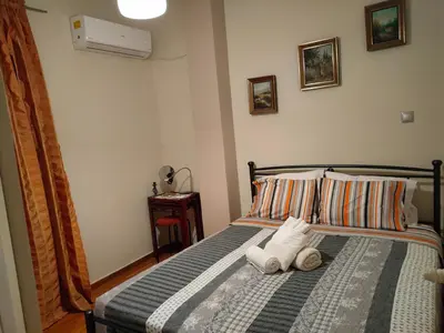 a bedroom with a bed with two towels on it at Cosy penthouse next to metro in Athens