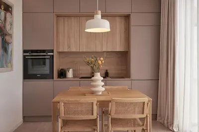 a dining room table with chairs and a vase with flowers at Charitos Heights Boutique Apt II, Kolonaki in Athens