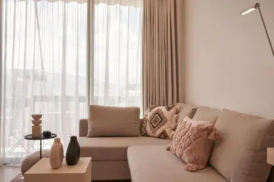 a living room with a couch and a large window at Charitos Heights Boutique Apt II, Kolonaki in Athens